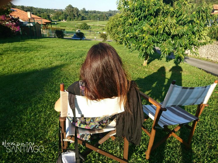 lugares donde dormir en el camino de santiago noelia descansando en una silla en un prado verde